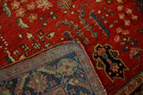 Folded corner of the vintage Persian rug revealing the hand-knotted foundation and wool pile.