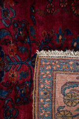Vintage Lilihan rug displaying hand-knotted back, fringe, and ruby red sapphire floral pile.