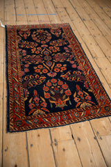 Angled view of an antique Mohajeran Sarouk runner with floral sprays on a deep cobalt blue ground.