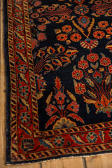 Corner detail of an antique Mohajeran Sarouk with floral sprays, vines, and a brick red border.