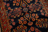Close-up of the short, dense pile and floral motifs on the cobalt blue field of an antique Persian Sarouk rug.