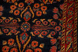 Cobalt blue field with floral sprays and a red border detail on an antique Mohajeran Sarouk rug.