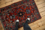 Personal viewpoint of a vintage Bijar rug showing its scale and red and blue traditional pattern.
