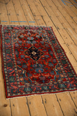 The dense, even wool pile and traditional floral motifs of a vintage Persian Bijar rug.