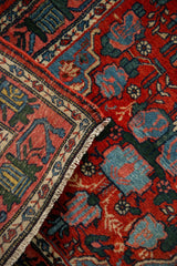Hand-knotted fringe and intact side cord selvage on a vintage Persian Bijar rug corner.