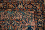 Antique Farahan Sarouk rug corner with a detailed floral border in rust, teal, and sapphire blue.