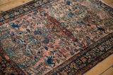 Angled view showing the storied texture and floral arabesques on a fine Farahan Sarouk rug.