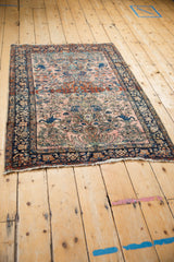 A long perspective of an antique Farahan Sarouk rug, showing the full artistic layout of its Lilihan-style design.