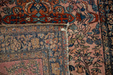 The hand-knotted foundation of an antique Farahan Sarouk rug is revealed at the folded corner.