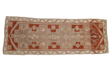Vintage distressed Kars runner rug with stepped geometric medallions in decorative copper, beige, and ivory.