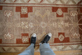 Close view of a vintage Kars runner's distressed, low-pile texture and earthy geometric motifs.