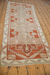 Perspective view of a distressed Kars runner's interconnected stepped medallions in copper and neutral beige.