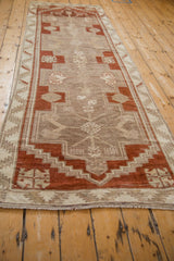 Long angled view of a vintage Kars runner with copper and beige geometric patterns.