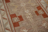 Even, low-pile wear on a distressed Kars rug with copper and beige geometric motifs.