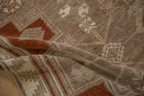 Earthy texture of a distressed Kars rug with visible knot heads in copper and beige.