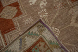 The hand-knotted reverse and distressed low pile of a vintage Turkish Kars rug corner.