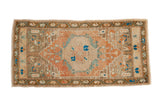 Distressed vintage Oushak runner with central peach, brown, and blue medallion, 2'1