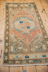 Vintage distressed Oushak runner, showing cantaloupe melon, blue, beige stepped medallion motifs with even wear.