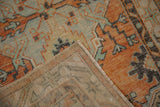 Distressed orange and blue pile, hand-knotted foundation, and painted numbers on Oushak rug reverse.