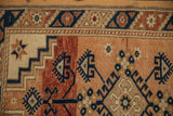 Stepped ivory corner spandrel with a starburst motif on a distressed Turkish Dosemealti rug.