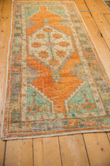 Worn foundation and muted terracotta, turquoise tones on a vintage Oushak runner.