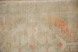Close-up of the distressed Oushak rug's worn pile, revealing knot heads and time-softened colors.