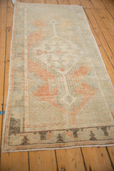 Angled view of a distressed Oushak runner highlighting its heavy abrash and soft color palette.