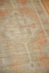 Close-up showing the low, textured pile and heavy abrash of a distressed vintage Oushak rug.