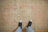 Distressed vintage Oushak rug pile in soft pink, ivory, and faded floral designs.