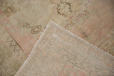 Hand-knotted vintage distressed Oushak rug: reverse and soft pink, ivory pile texture.