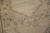 Even wear across the low pile of a distressed Oushak rug revealing the knot heads.