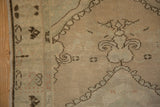 A corner of the Oushak runner showing its low, even pile and intact side cord selvage.