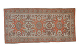 Distressed vintage Oushak runner, burnt orange geometric medallions, pale silver field, subtle animal motifs.