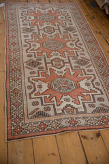 Distressed Oushak runner with arrowed geometric medallions and intricate border motifs.