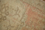 Textural wear to the knot heads on a distressed Oushak rug in dusty rose and ivory.