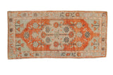 Distressed vintage Oushak runner with a brick red shield medallion and faded mint green corner spandrels.