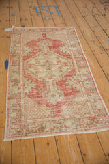 The full length of the vintage distressed Oushak runner seen from an angle.