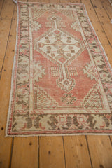 Distressed texture of vintage Oushak runner border in dusty red blush and ivory.