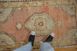 Low pile and abrashed texture on the center medallion of a distressed vintage Oushak rug.