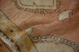 Soft texture and abrashed low pile of a hand-knotted distressed vintage Oushak rug.