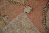Corner view of a vintage Oushak rug revealing its hand-knotted foundation and weave.