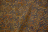Distressed Anatolian rug with ram's horn geometric patterns in faded cobalt blue, gold, and bronze.
