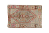 Vintage distressed Oushak rug, geometric stepped medallion with pale aubergine, silver, and faded magenta.