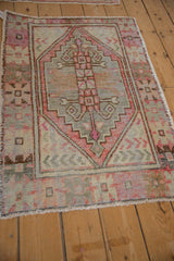 Faded magenta and silver tones across the textured pile of a distressed Oushak rug.