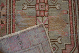 Distressed Oushak rug's pile texture, intact side selvage, and woven blue-grey foundation.