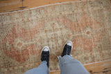 Low-pile, distressed texture on a vintage Oushak runner with dusty rust and sea foam colors.