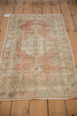 Angled side view of the distressed Oushak runner, showing its faded rust and sea foam pattern.