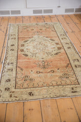 Distressed Oushak runner's pile with visible abrasions in dusty terracotta, ivory, and chocolate brown.
