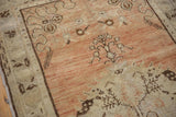 Distressed Oushak runner showing worn dusty terracotta pile with sandalwood tones and faint foundation.