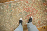A vintage distressed Oushak rug shown underfoot to feature its soft, time-worn texture and muted colors.